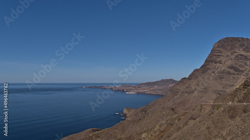 Beautiful view over the western coast of island Gran Canaria  Canary Islands  Spain with steep cliffs and village Puerto de las Nieves in background.
