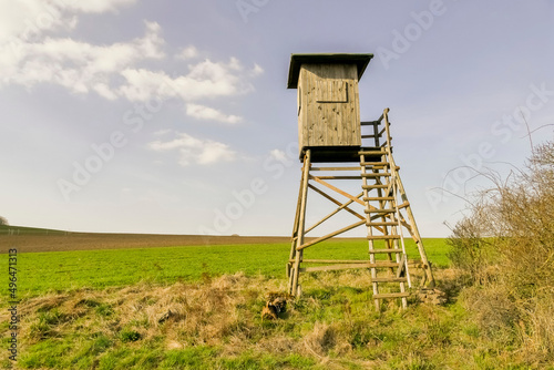 An observation tower for rangers stands in a field.