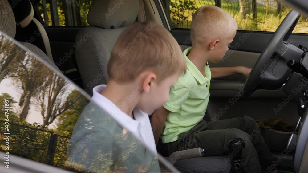 Two boys are playing in the car while driving, they imagine themselves as adult drivers. Two boys are playing in the car while driving, they imagine themselves as adult drivers.