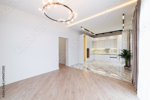 interior design of a room with white walls and a large kitchen