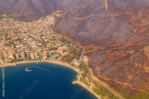 Trees burnt in forest fires of July 2021 in Marmaris resort town of Turkey from helicopter. Aerial view of Beautiful blue bays ans sea