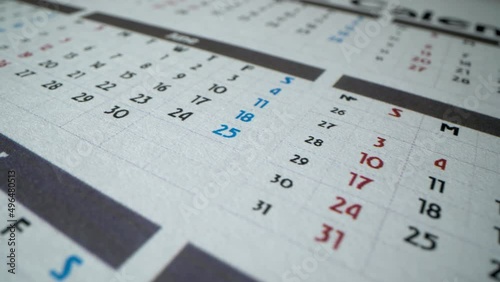 June and July 2022. Calendar with many business days and holidays. July 4th. Macro shot. Detailed calendar 2022. Rotating closeup.