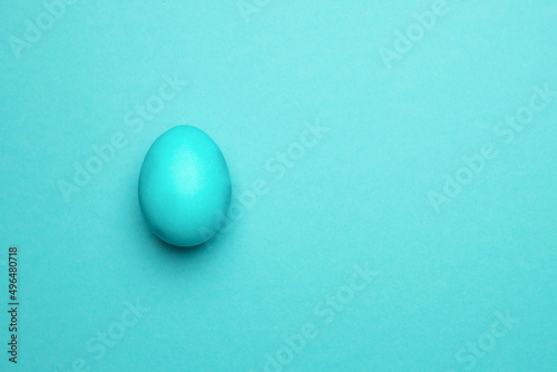 Blue Easter egg on a blue background.