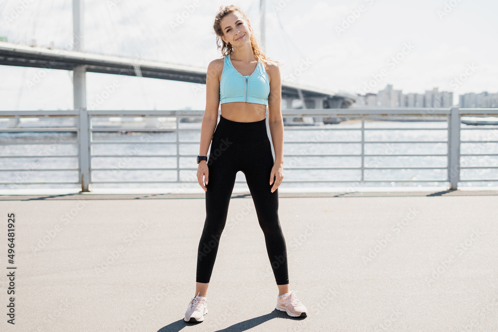 Athletic woman active outdoor workout, stretching and body warm-up, sportswear Athletic woman active outdoor workout, stretching and body warm-up, sportswear