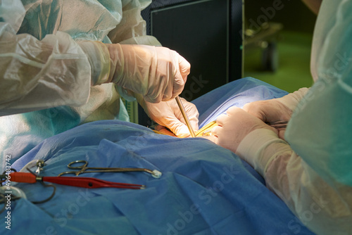 performing a surgical operation. hands of doctors close-up and medical instrument