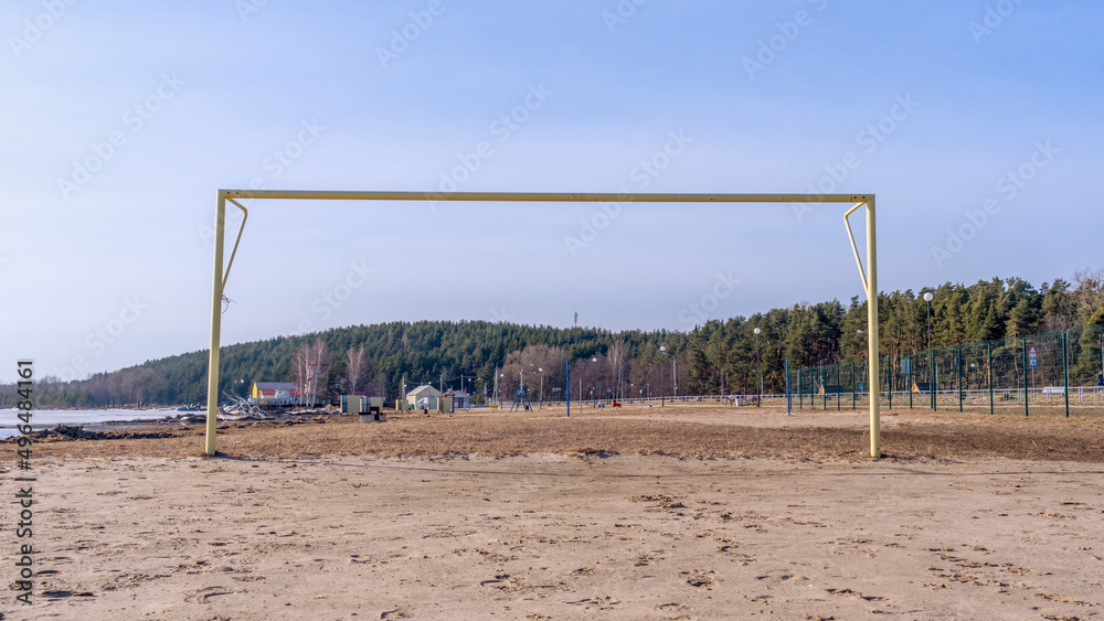 Soccer goal post on the beach with sand and blue sky. Football gate, beach soccer. Football gate at empty beach.