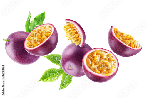Group of flying ripe passion fruits whole and in half with leaves isolated on a white background.