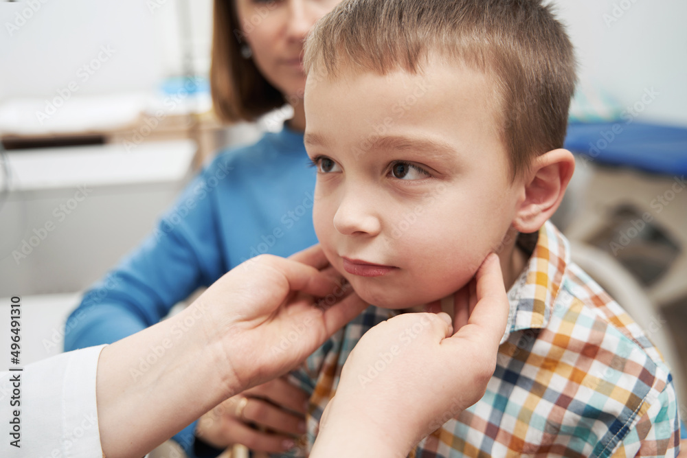 Doctor hands palpating child lymph nodes with fingers Doctor hands palpating child lymph nodes with fingers