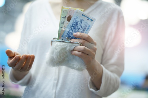 Woman taking out money from purse
