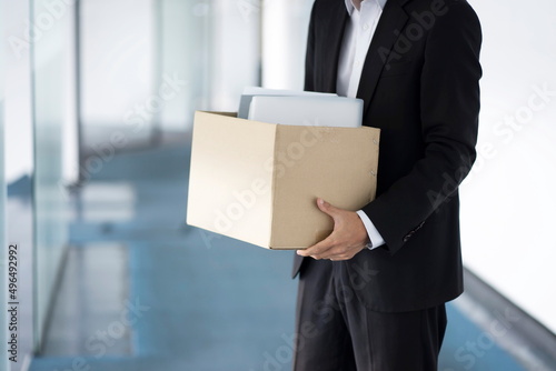 Fired businessman carrying box of personal items © 상은 신