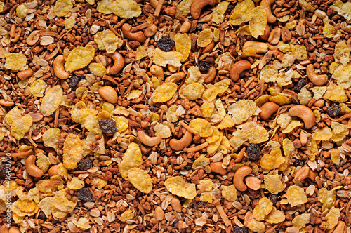 Granola. Texture top view. With corn flakes, chestnuts, raisins, oats, etc. Breakfast food.