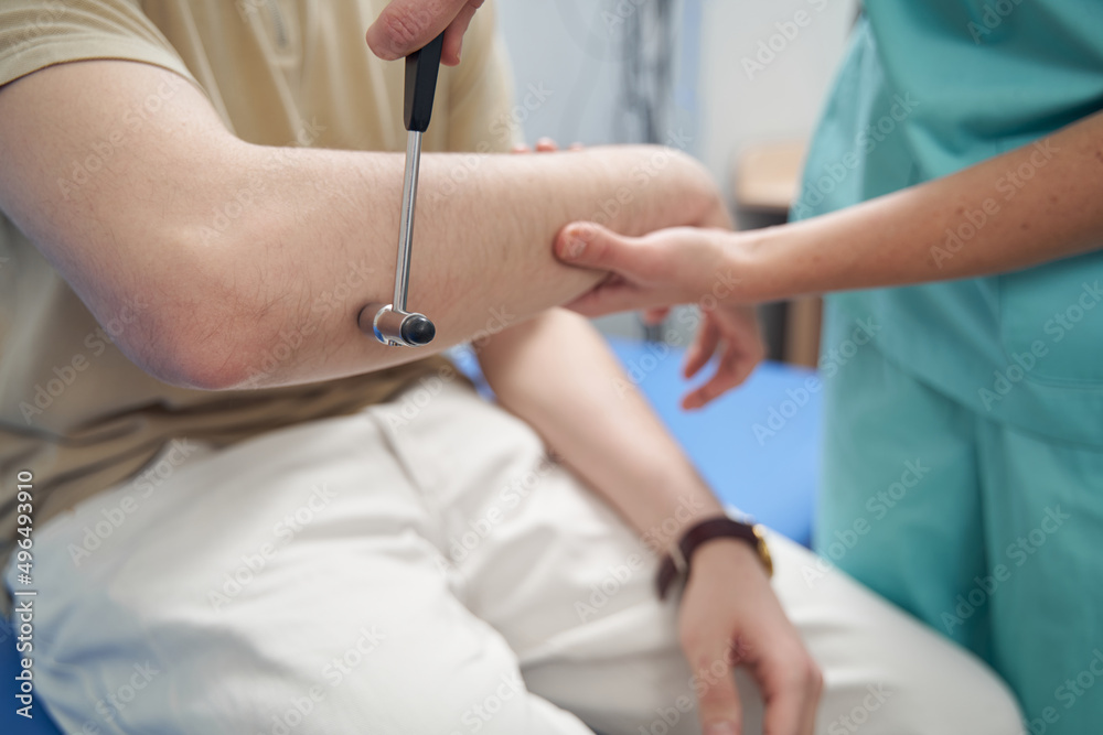 Female neurologist doing check up of male patient Female neurologist doing check up of male patient