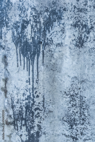 Blue painted concrete surface old stained paint wall texture spilled cement streaks background © Andrey