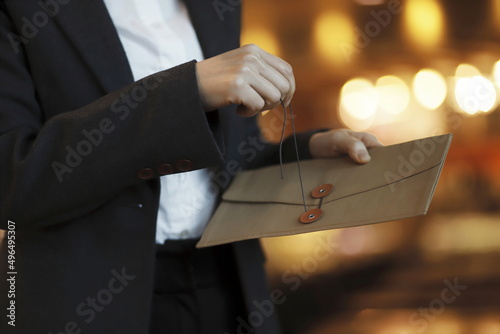Cropped image of businesswoman opening envelope 