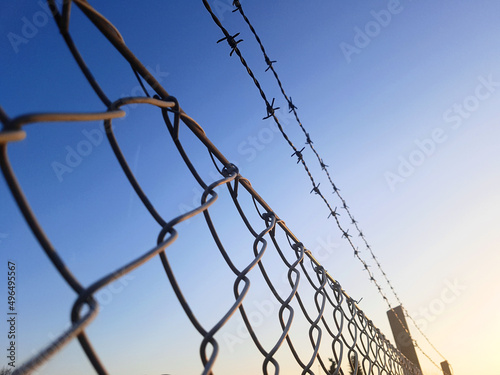 Barbed wire and fence surrounding private property or military zone