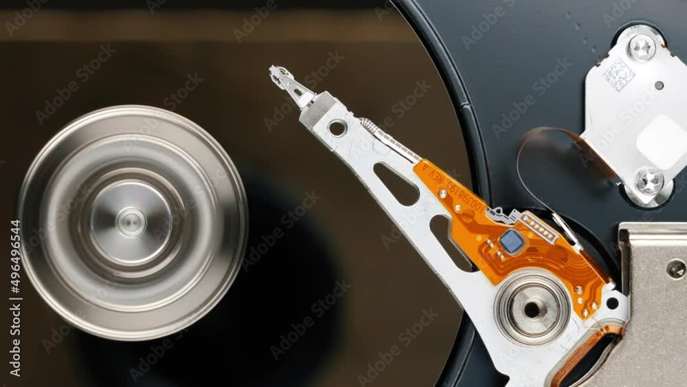 Hard disk drive turning on. HDD platter inside. Closeup view from top Hard disk drive turning on. HDD platter inside. Closeup view from top