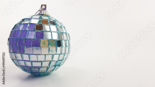 The Christmas tree toy in the form of a ball is decorated with a mirror . the color of the very peri on a white background. space for text