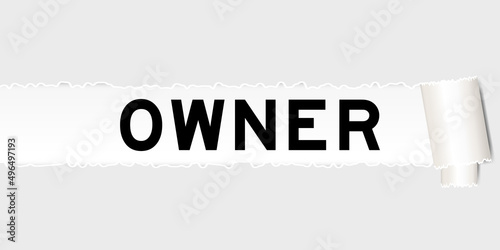 Ripped gray paper background that have word owner under torn part