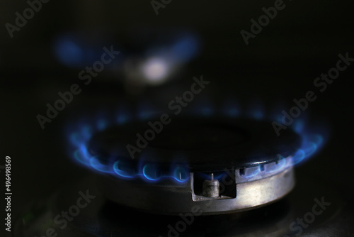 blue flame of burning gas in the kitchen stove