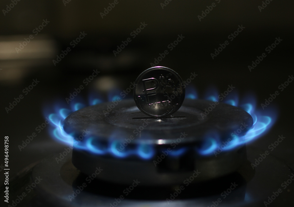 coin on the background of a burning gas flame coin on the background of a burning gas flame