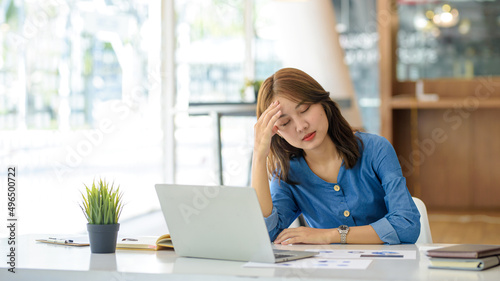 Free Download Asian women sitting in an office with stress and eye strain tired, portrait of sad unhappy tired frustrated disappointed lady suffering from migraine sitting at the table, Sick worker concept. - GFXLoad