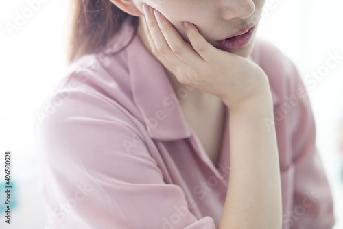 Woman suffering from toothache, tooth decay or sensitivity