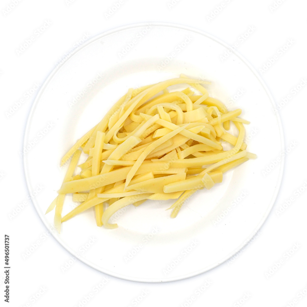 Sliced of bamboo shoots on white dish, isolated on white background. One of the ingredients for Asian cuisines. spot focus