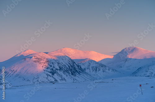 Last, pink, sunlight on the mountains of Swedish Lapland in winter.