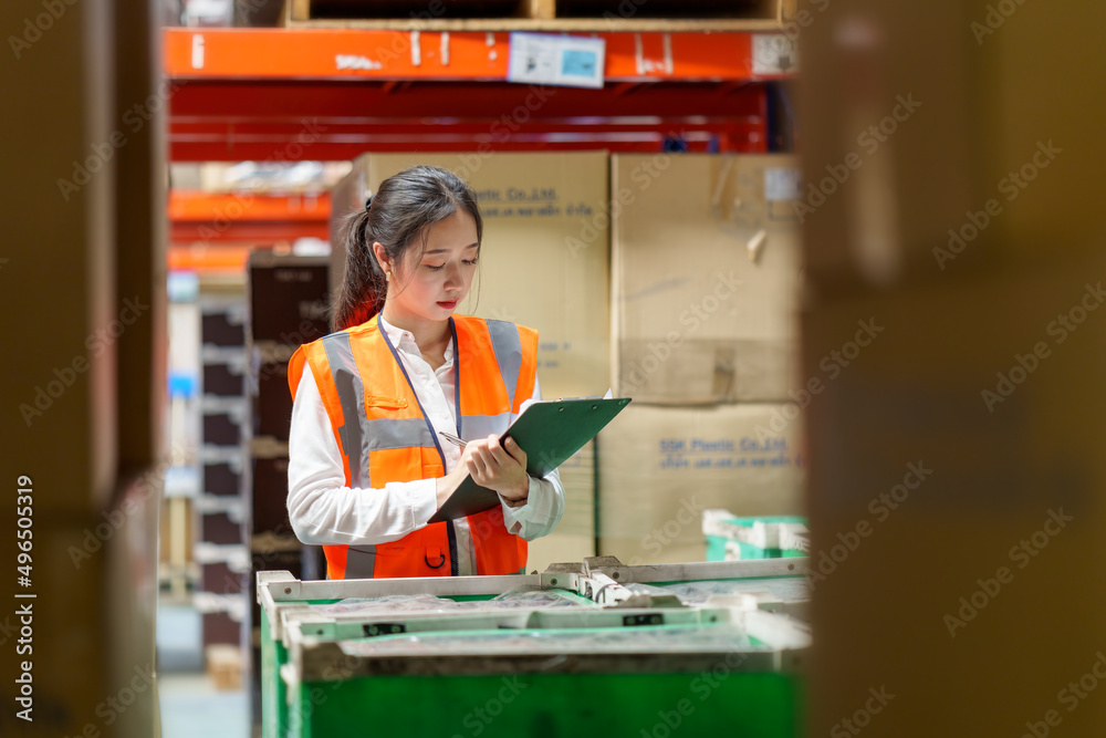 Women warehouse worker with digital tablet.