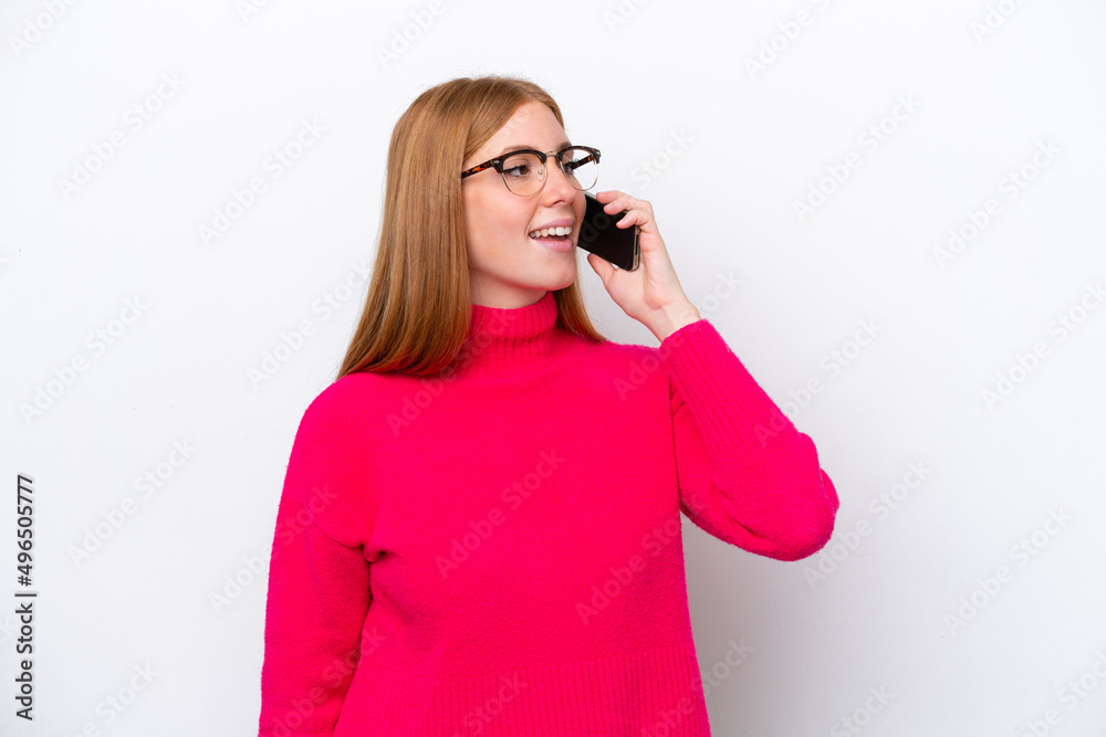 Young redhead woman isolated on white background keeping a conversation with the mobile phone Young redhead woman isolated on white background keeping a conversation with the mobile phone