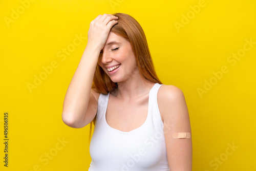 Young redhead woman wearing a band-aids isolated on yellow background has realized something and intending the solution