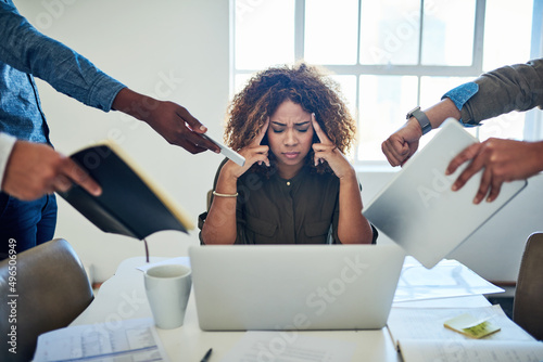 I cant deal with all the demands. Shot of a stressed out young woman working in a demanding career.