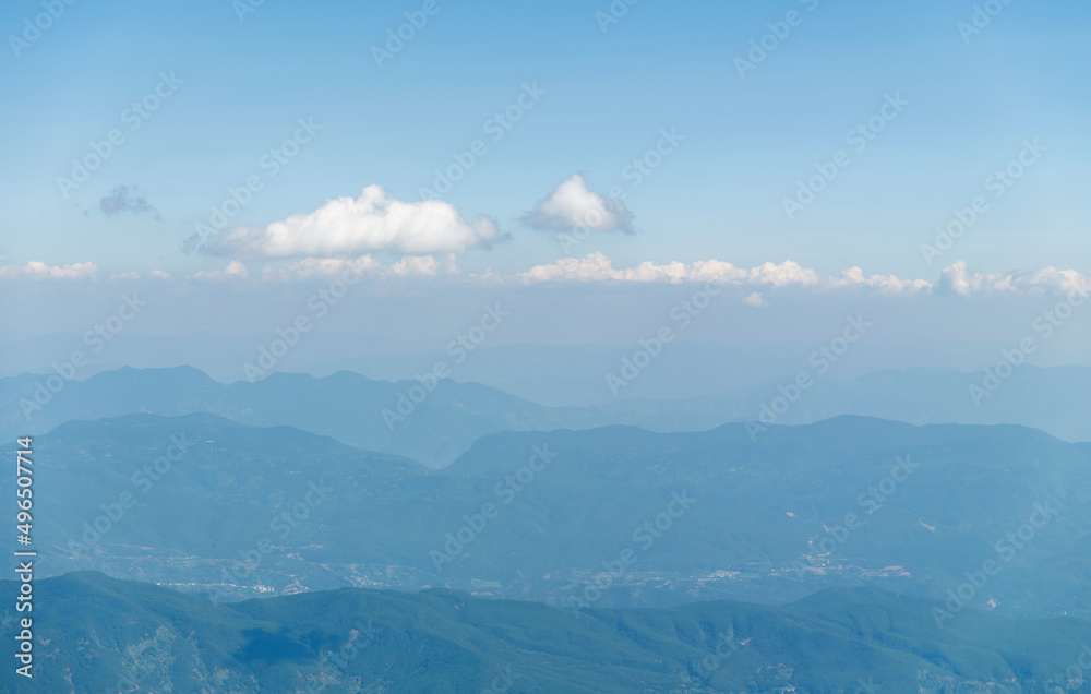 Top view cloudy mountains from a plane