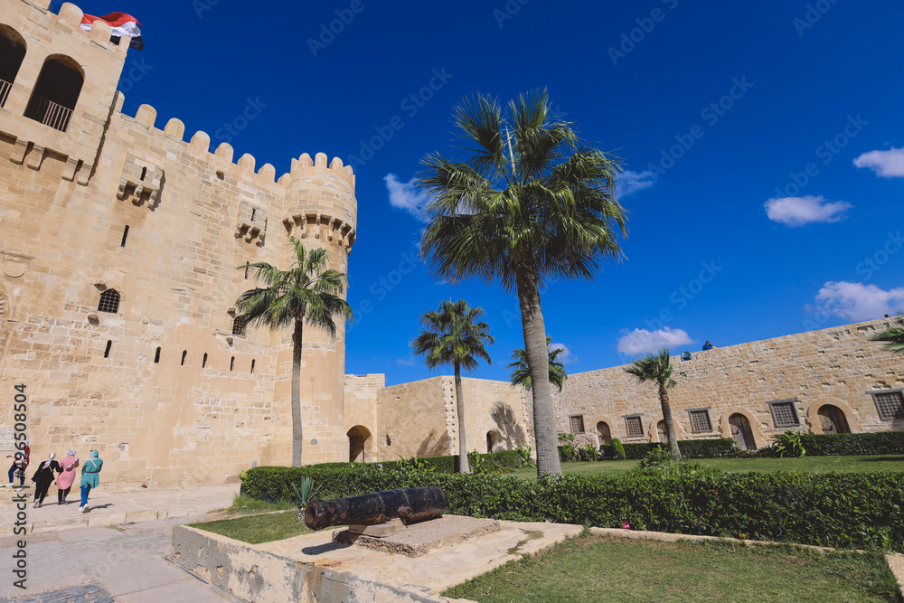 View to the 15th-century defensive fortress Citadel of Qaitbay with no people around, located on the Mediterranean sea coast, in Alexandria, Egypt 