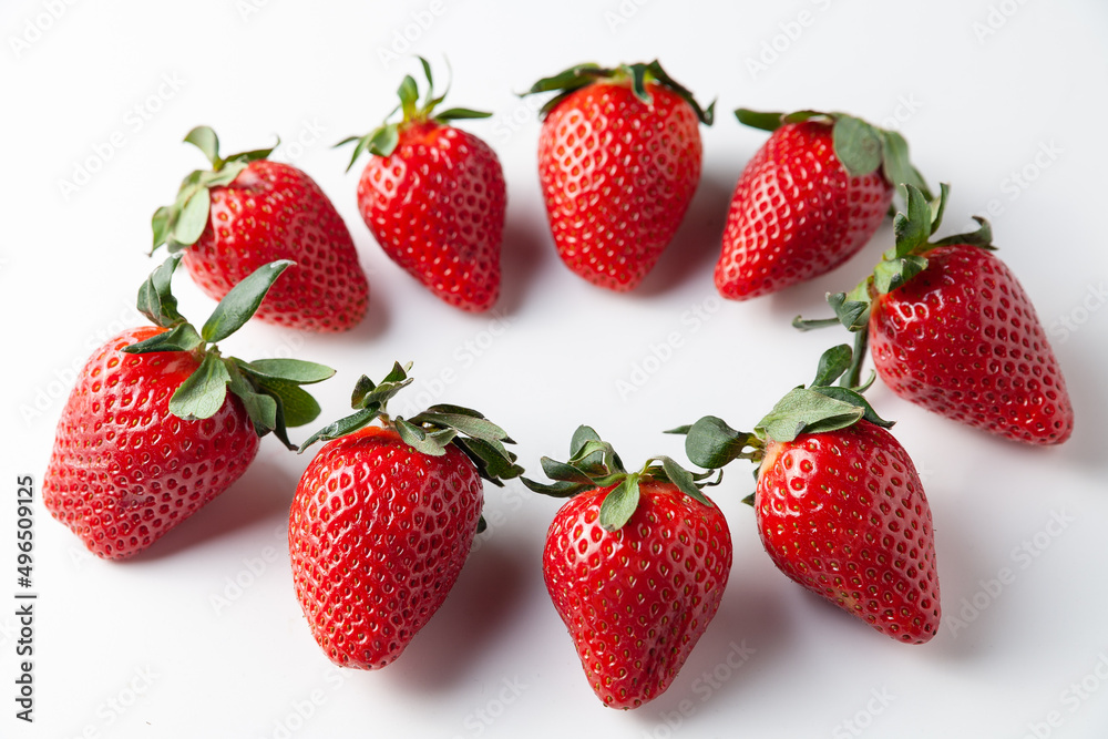 Strawberries lie in a circle on the table. On a white background. Selective focus. Strawberries lie in a circle on the table. On a white background. Selective focus.