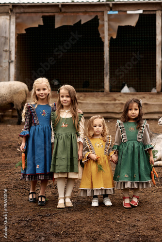 cute children in beautiful green dresses walking on a farm © jul14ka