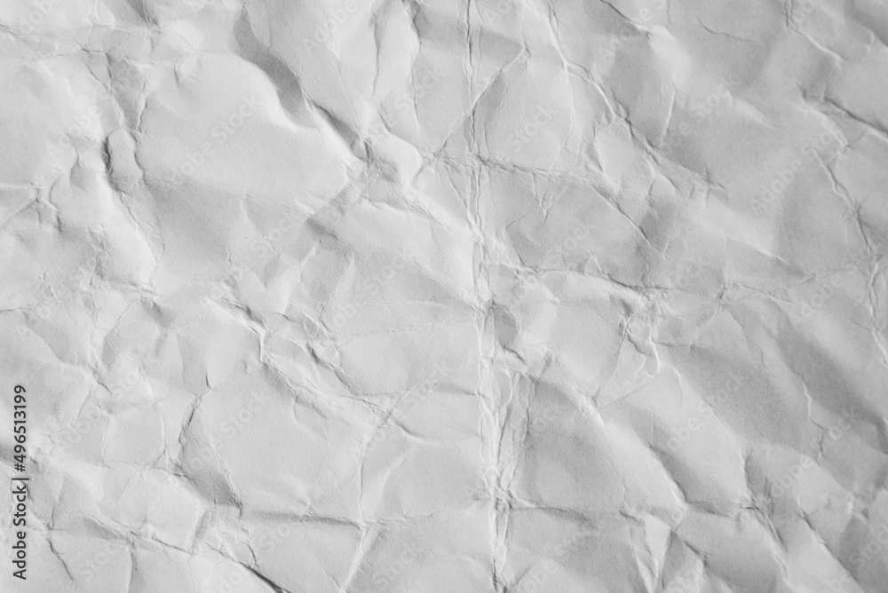 Obraz premium Close-up of crumpled sheet of white paper. Top view textured uneven paper background, macro photography
