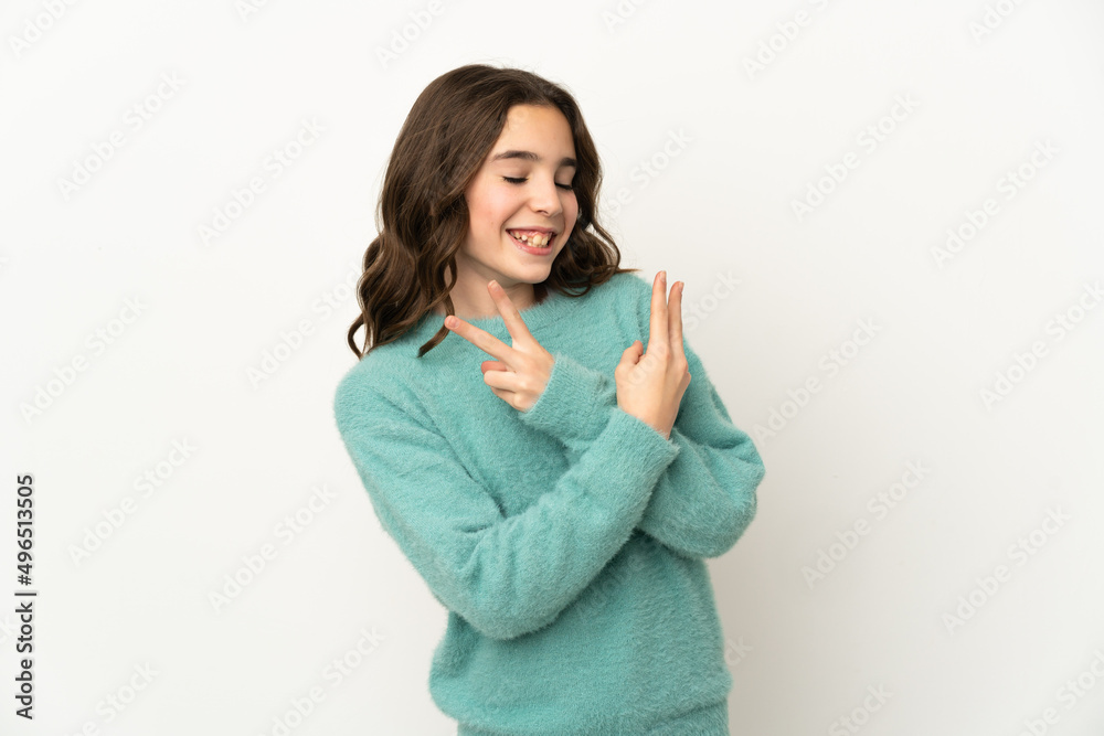 Little caucasian girl isolated on white background smiling and showing victory sign Little caucasian girl isolated on white background smiling and showing victory sign