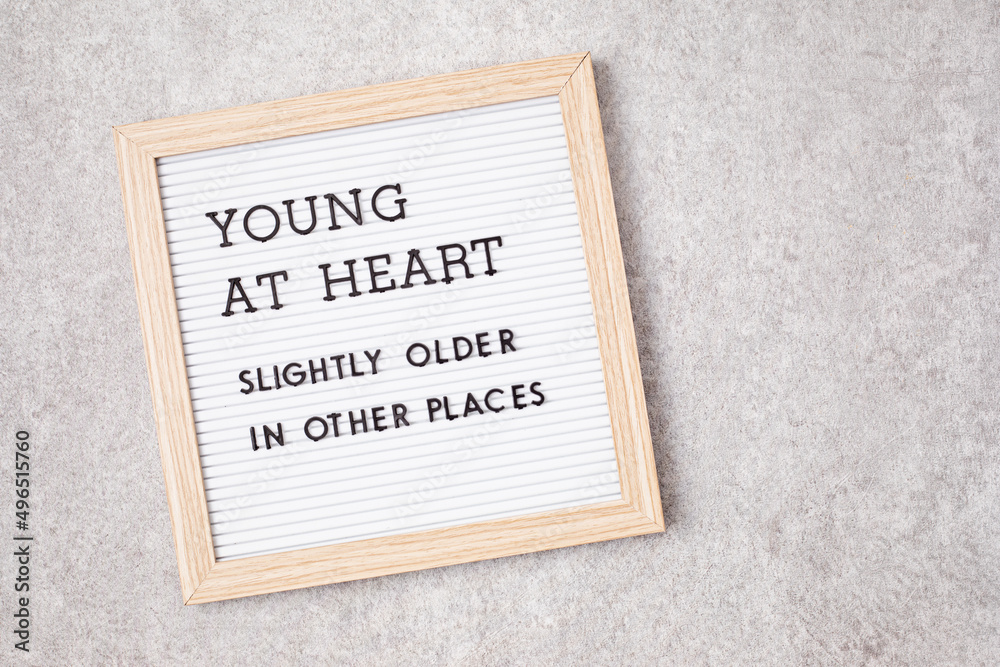 Obraz premium Letter board with text young at heart, slightly older in other places. Ageing concept