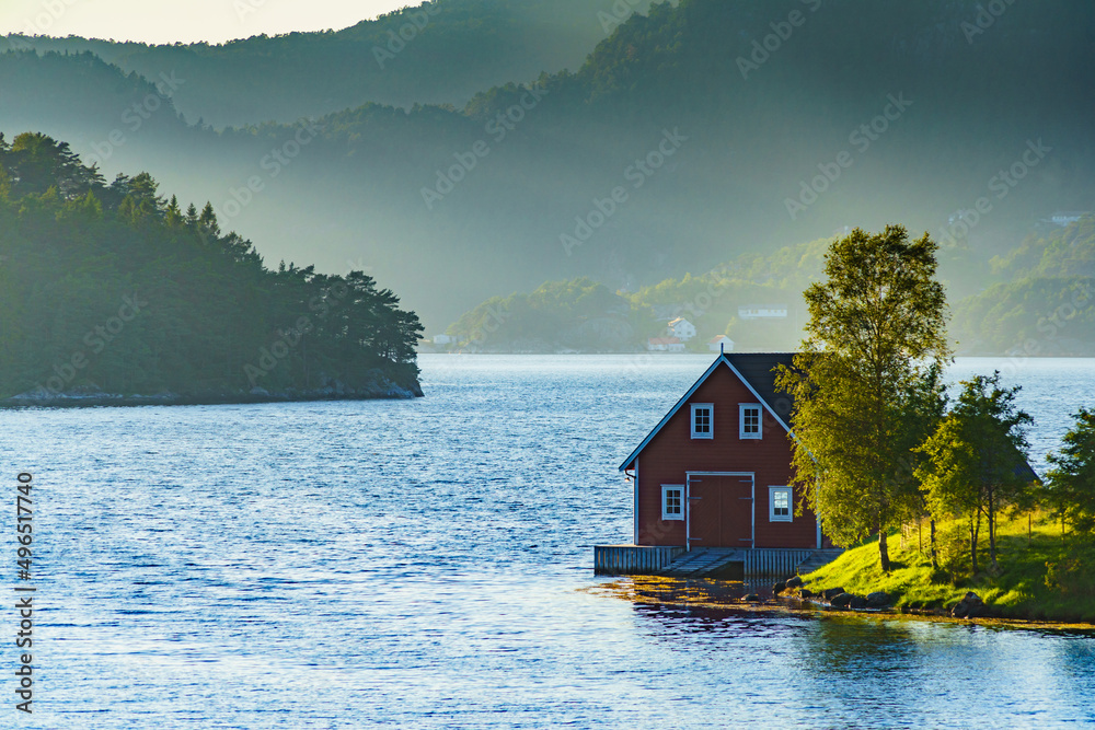 Wooden cabin on fjord shore, Norway