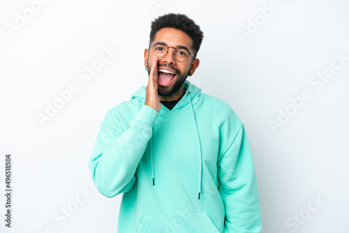 Young Brazilian man isolated on white background shouting with mouth wide open
