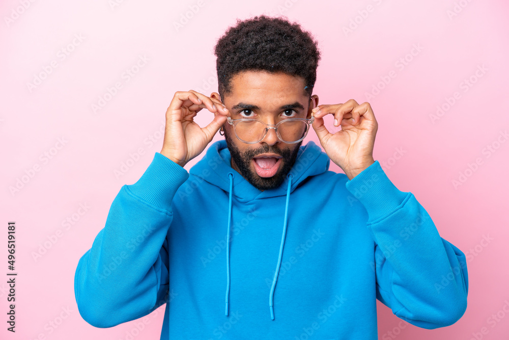 Young Brazilian man isolated on pink background With glasses and surprised expression Young Brazilian man isolated on pink background With glasses and surprised expression
