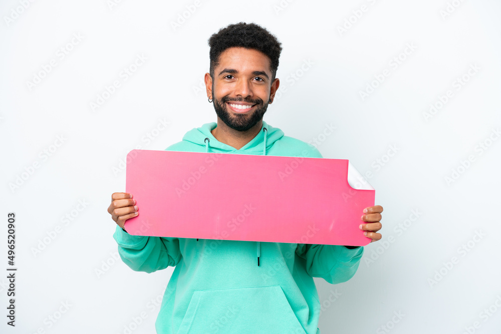 Young Brazilian man isolated on white background holding an empty placard Young Brazilian man isolated on white background holding an empty placard