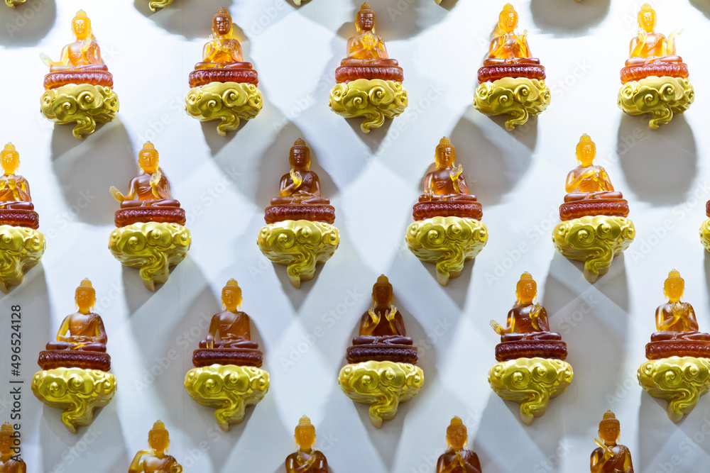 Group of Buddha statues on the wall