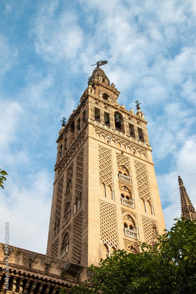 Low angle view of bell tower over Seville cityscape, Andalusia, Spain