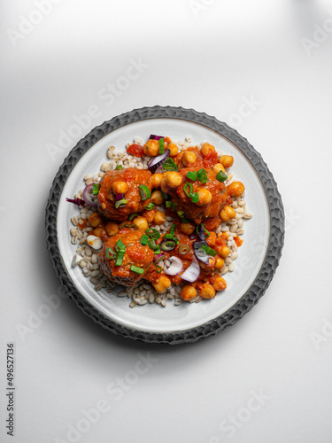 Polpette - meatballs with tometo sauce,  on a ceramic plate, with a white background photo