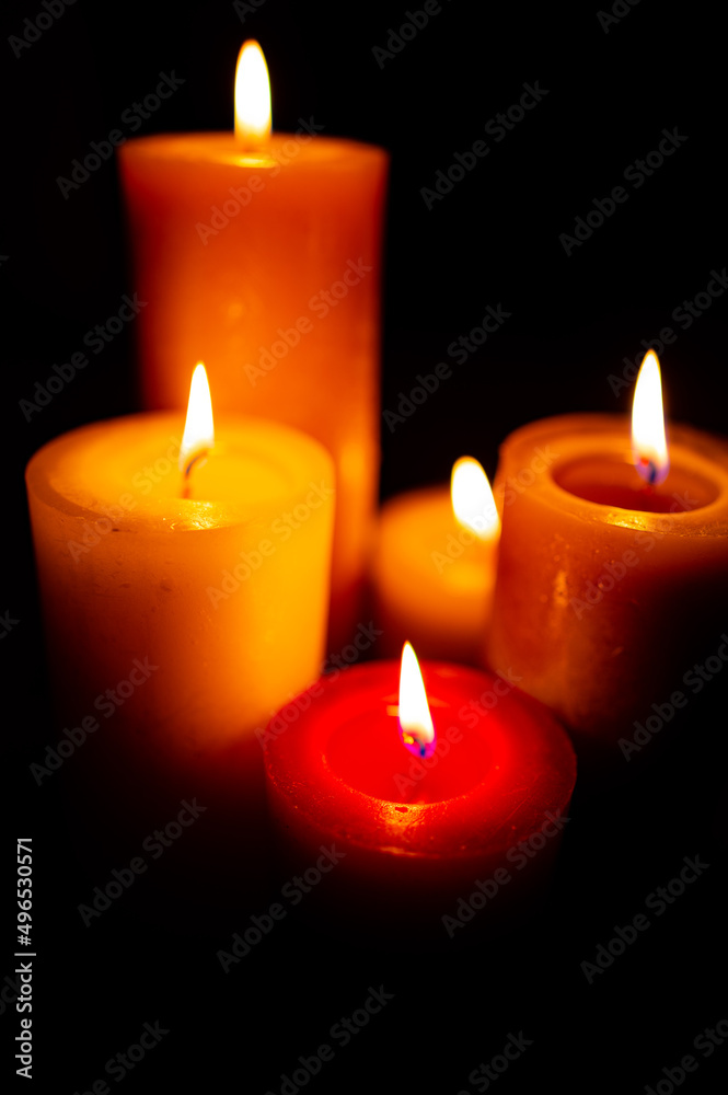 Burning red candles on black background Burning red candles on black background