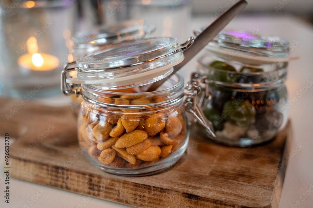 Glass jars with healthy party snacks served in bar, tasty appetisers Glass jars with healthy party snacks served in bar, tasty appetisers