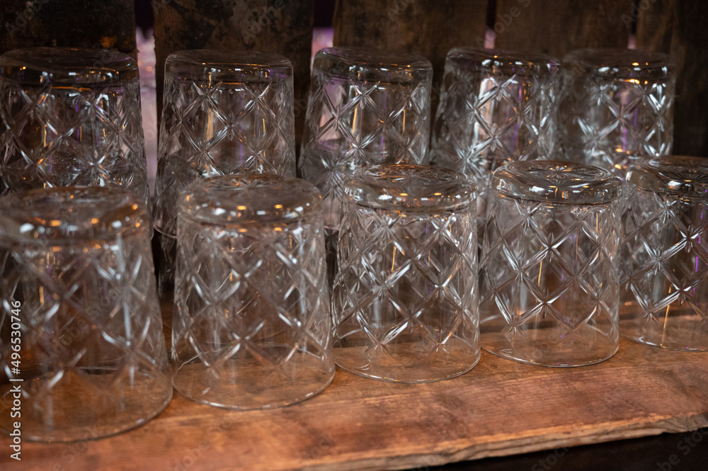 Many clean crystal glasses for water and drinks close up