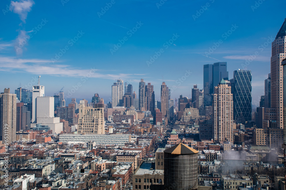 A shot of a Manhattan skyline with skyscrapers reaching up into the sky above the streets of New York